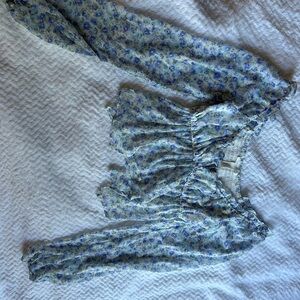 Blue blouse with flowers, see through under the breast area